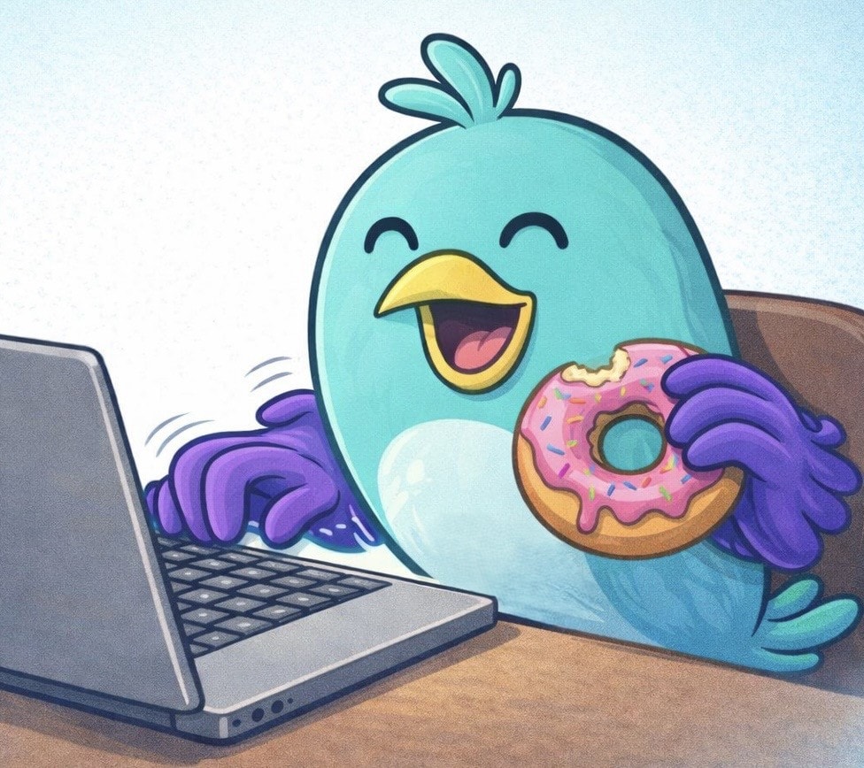 Breezy relaxing at his laptop with a donut